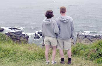 A couple watches waves from a South Coast overlook.